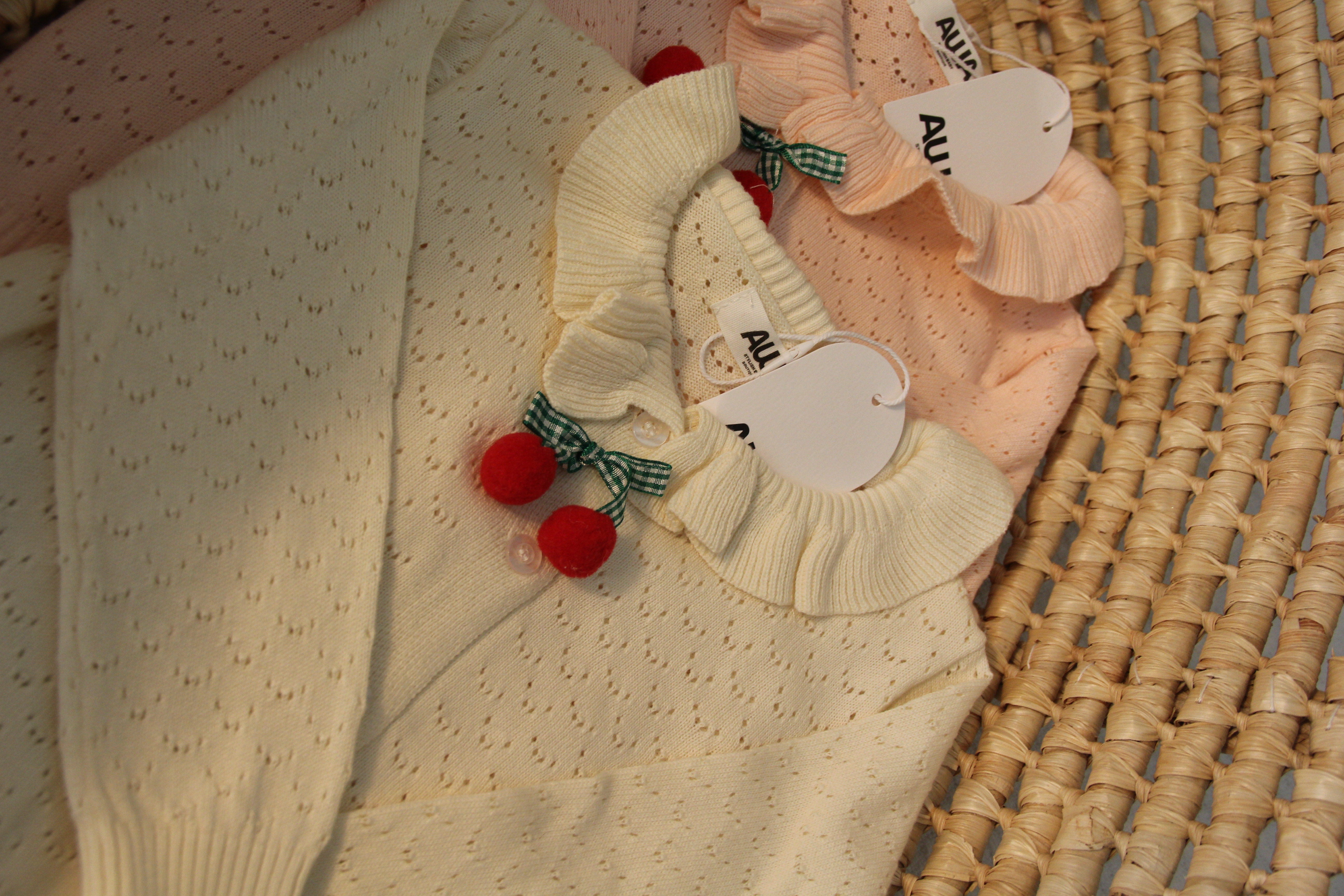 Baby girl cherry pom-pom cardigan in light apricot and blush pink with ruffle collar pointelle knit – AWA Baby