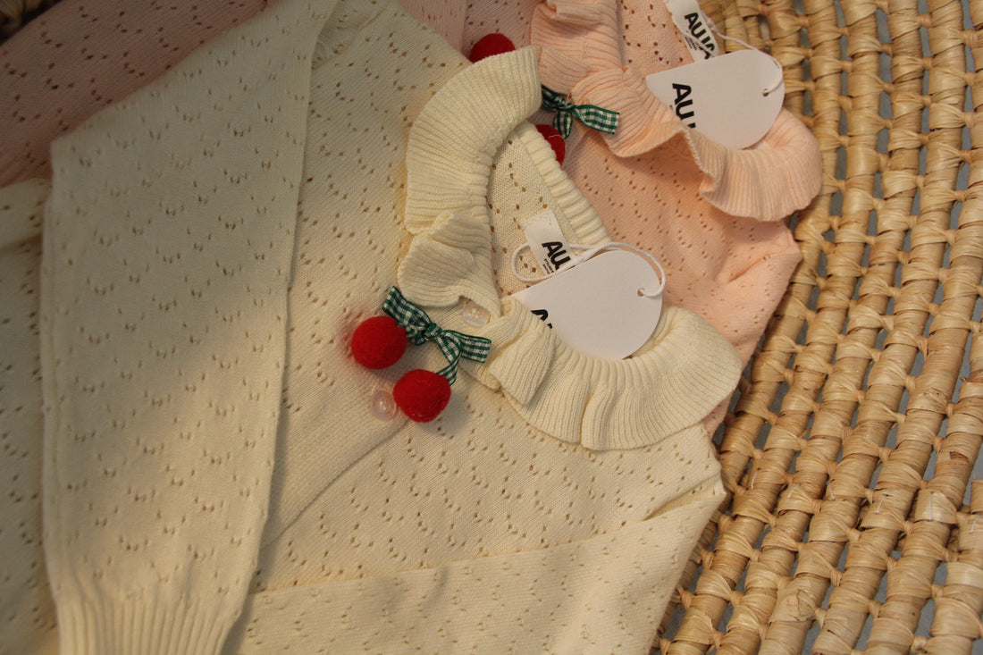 Baby girl cherry pom-pom cardigan in light apricot and blush pink with ruffle collar pointelle knit – AWA Baby